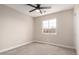 Spacious bedroom with ceiling fan, carpet, and large window at 8773 W Pineveta Dr, Arizona City, AZ 85123