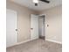 Bright bedroom with ceiling fan, carpet, and doors to other rooms at 8773 W Pineveta Dr, Arizona City, AZ 85123