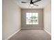 Spacious bedroom with large window and ceiling fan at 8773 W Pineveta Dr, Arizona City, AZ 85123