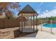 Charming gazebo nestled in the backyard, near the pool at 8773 W Pineveta Dr, Arizona City, AZ 85123