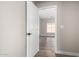 Hallway with door to bedroom and wood-look tile floor at 8773 W Pineveta Dr, Arizona City, AZ 85123