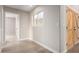 Bright hallway with tile flooring, leading to bedrooms and other rooms at 8773 W Pineveta Dr, Arizona City, AZ 85123