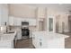 Modern kitchen with white cabinets, stainless steel appliances and a large island at 8773 W Pineveta Dr, Arizona City, AZ 85123