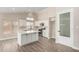 Modern kitchen with white cabinets, quartz countertops, and an island at 8773 W Pineveta Dr, Arizona City, AZ 85123