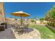 Landscaped backyard with patio furniture and umbrella at 9555 W Escuda Dr, Peoria, AZ 85382