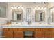 Bathroom with double vanity, granite countertop, and large mirrors at 9555 W Escuda Dr, Peoria, AZ 85382