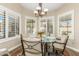 Bright breakfast nook with a glass table, chairs, and view to the backyard at 9555 W Escuda Dr, Peoria, AZ 85382