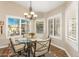 Kitchen breakfast nook with glass table and chairs, and view to backyard at 9555 W Escuda Dr, Peoria, AZ 85382