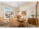 A formal dining room with a wood table and chairs, hardwood floors, and decorative accents at 9555 W Escuda Dr, Peoria, AZ 85382