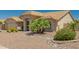 Tan house with tile roof, palm trees, and gravel landscaping at 9555 W Escuda Dr, Peoria, AZ 85382