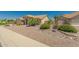 Single-story home with desert landscaping and a two-car garage at 9555 W Escuda Dr, Peoria, AZ 85382