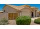 House exterior showcasing a wooden gate and drought-resistant landscaping at 9555 W Escuda Dr, Peoria, AZ 85382