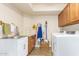 Laundry room with washer, dryer, sink and extra storage at 9555 W Escuda Dr, Peoria, AZ 85382