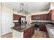 Granite countertops and dark wood cabinets highlight this kitchen at 968 S Western Skies Dr, Gilbert, AZ 85296