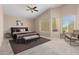 Spacious main bedroom with a king-size bed, sitting area, and large windows at 968 S Western Skies Dr, Gilbert, AZ 85296