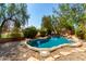 Inviting kidney-shaped pool surrounded by rocks and desert landscaping at 968 S Western Skies Dr, Gilbert, AZ 85296