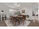 Dining room with mid-century modern furniture and a view into the living room at 9765 W Pontiac Dr, Peoria, AZ 85382