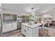 Modern kitchen featuring white cabinets, granite island, and stainless steel appliances at 9765 W Pontiac Dr, Peoria, AZ 85382