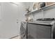 Convenient laundry room with washer, dryer, and shelving at 9765 W Pontiac Dr, Peoria, AZ 85382