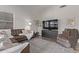 Living room with L-shaped brown leather couch and a large TV at 9765 W Pontiac Dr, Peoria, AZ 85382