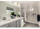 Bright bathroom features a double vanity, a large mirror, and a glass-enclosed shower at 10029 E Tahoe Ave, Mesa, AZ 85212