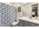 Bathroom with a shower/tub combo, gray vanity, white countertop, and a blue and white shower curtain at 10029 E Tahoe Ave, Mesa, AZ 85212