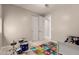 Bedroom for children featuring alphabet rug, drum set, toys, and a ceiling fan at 10029 E Tahoe Ave, Mesa, AZ 85212