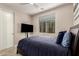 Bedroom features a window for natural light, a ceiling fan, and a comfortable queen-sized bed at 10029 E Tahoe Ave, Mesa, AZ 85212