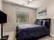 Bedroom features a window for natural light, a ceiling fan, and a comfortable queen-sized bed at 10029 E Tahoe Ave, Mesa, AZ 85212