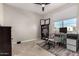 Bedroom with a desk, chair, bookcase, and a window for natural light, ideal for study or work at 10029 E Tahoe Ave, Mesa, AZ 85212
