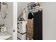 Walk-in closet containing boxes and black cabinet in a light grey small room at 10029 E Tahoe Ave, Mesa, AZ 85212