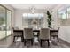 Bright dining room features a stylish chandelier, large windows, and modern decor at 10029 E Tahoe Ave, Mesa, AZ 85212