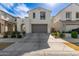 Two-story home featuring a two car garage, beautiful landscaping, and an arched entryway at 10029 E Tahoe Ave, Mesa, AZ 85212