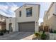 Two-story home featuring a two-car garage, beautiful landscaping, and an arched entryway at 10029 E Tahoe Ave, Mesa, AZ 85212