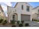 Two-story home featuring a two-car garage, a welcoming wreath on the front door, and lush landscaping at 10029 E Tahoe Ave, Mesa, AZ 85212
