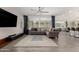 Open-concept living room features a modern ceiling fan, recessed lights, and a comfortable gray sofa at 10029 E Tahoe Ave, Mesa, AZ 85212