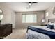 Inviting main bedroom features soft carpeting, a ceiling fan, and a comfortable ambiance at 10029 E Tahoe Ave, Mesa, AZ 85212