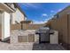 Outdoor kitchen area featuring a gas grill, sink, stone veneer, and drawers for storage at 10029 E Tahoe Ave, Mesa, AZ 85212