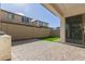 This covered patio features pavers, a small patch of artificial turf, and a gas grill at 10029 E Tahoe Ave, Mesa, AZ 85212