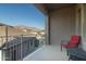 Spacious balcony with red chair and mountain views at 10196 E Legend Trl, Gold Canyon, AZ 85118