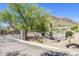 Gated community entrance with landscaping and signage at 10196 E Legend Trl, Gold Canyon, AZ 85118