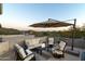 Spacious rooftop patio furniture with sunset mountain views at 10196 E Legend Trl, Gold Canyon, AZ 85118