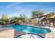 Inviting community pool with spa and shaded lounge area at 10196 E Legend Trl, Gold Canyon, AZ 85118