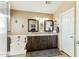 Bright bathroom featuring dual sinks, a granite countertop, tub and tile flooring at 10282 E Trailhead Ct, Gold Canyon, AZ 85118