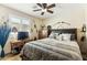 Well decorated bedroom with ceiling fan and lots of decorative art at 10282 E Trailhead Ct, Gold Canyon, AZ 85118