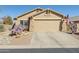 Charming single-story home with desert landscaping, neutral tones, and a spacious two-car garage at 10282 E Trailhead Ct, Gold Canyon, AZ 85118