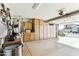 Well-organized garage with ample storage cabinets and epoxy flooring, leading to the outdoors at 10282 E Trailhead Ct, Gold Canyon, AZ 85118