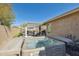 Backyard hot tub with surrounding patio and partial shade structure at 10282 E Trailhead Ct, Gold Canyon, AZ 85118