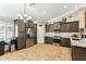 Modern kitchen with stainless steel appliances, granite countertops, and dark wood cabinetry at 10282 E Trailhead Ct, Gold Canyon, AZ 85118