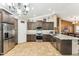 Stylish kitchen featuring granite countertops, stainless appliances, tile backsplash, and dark cabinets at 10282 E Trailhead Ct, Gold Canyon, AZ 85118